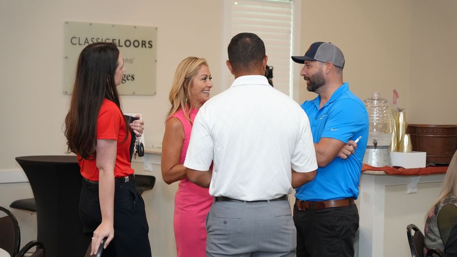 Four attendees converse together during the GOBA event.