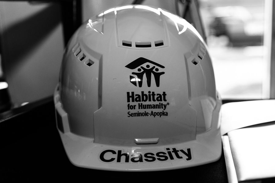 Black-and-white detail of a Habitat for Humanity hard hat.