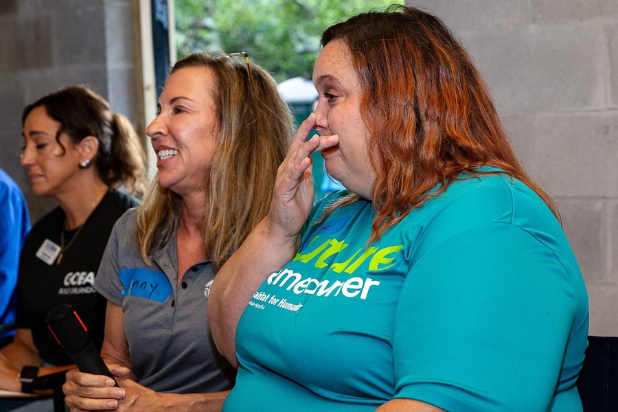 Two attendees listening and smiling during the group discussion.