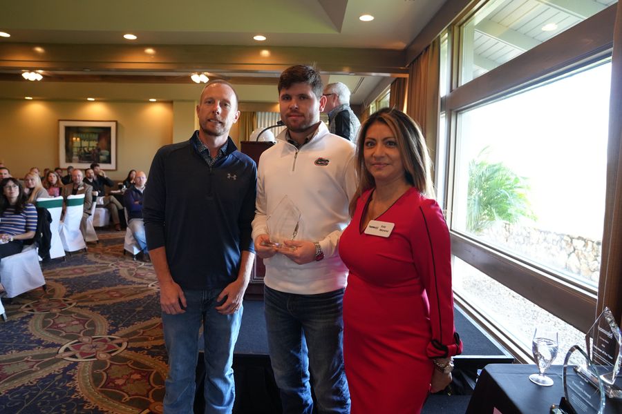 Three guests posing together at the HomeAid breakfast.