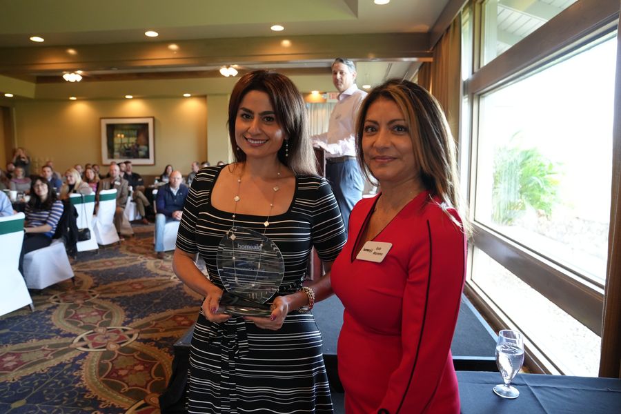 Award presentation portrait at the HomeAid breakfast.