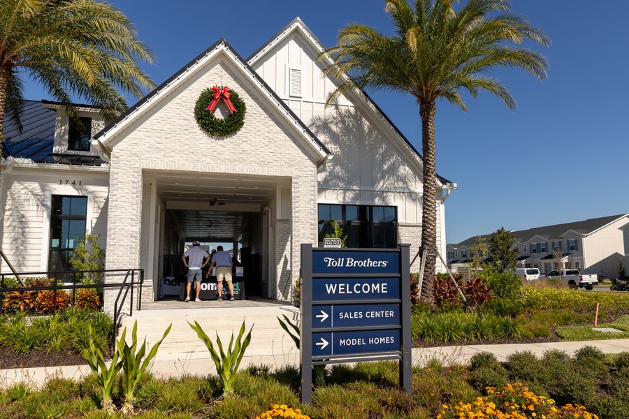 Palm trees frame the entrance to the cornhole tournament venue.