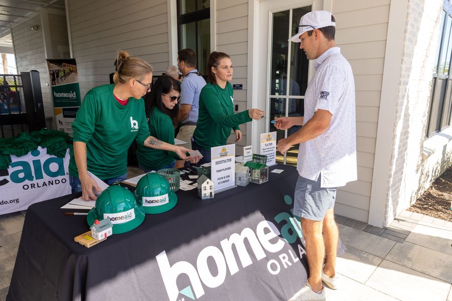 An attendee checks in at the HomeAid Orlando welcome table.
