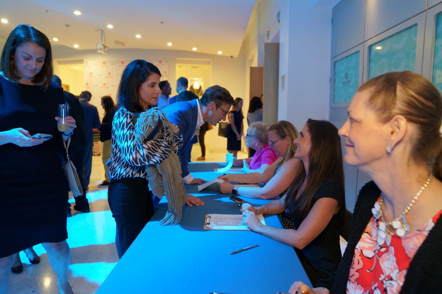 Guests checking in at the event registration table.