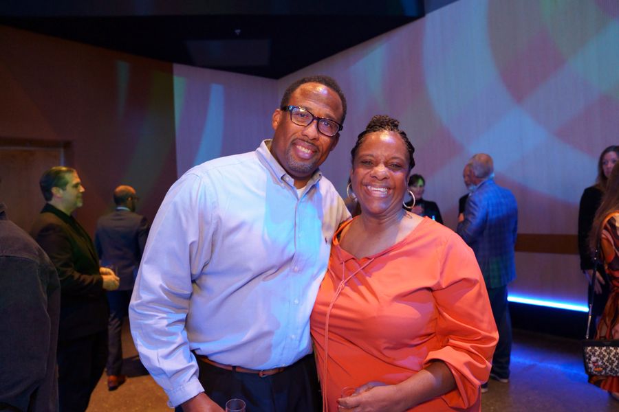 Two guests smiling together during the reception.