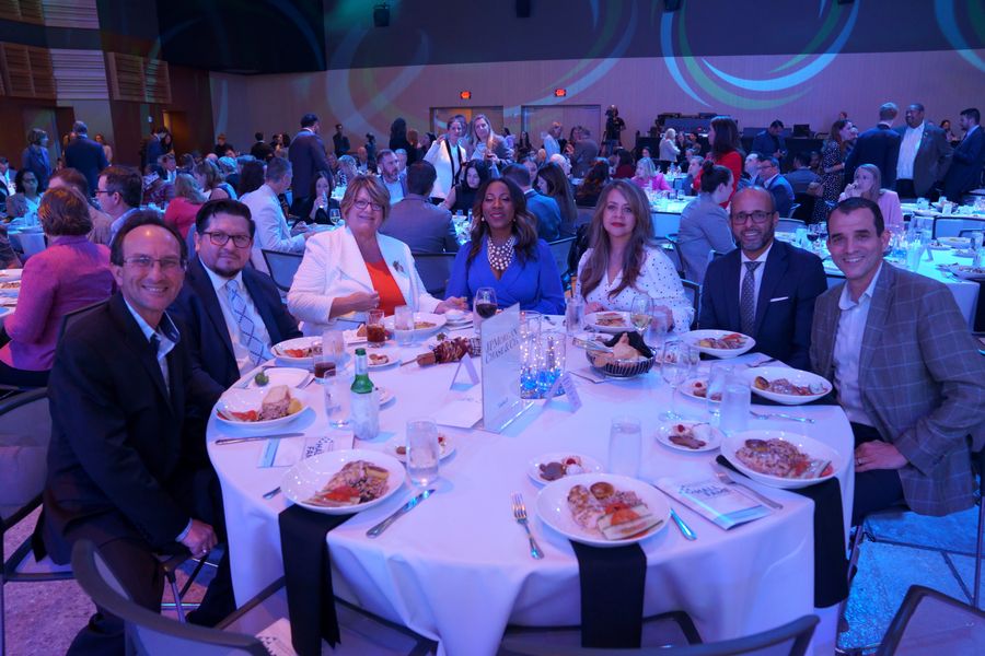 Guests gathered around a dinner table at the gala.