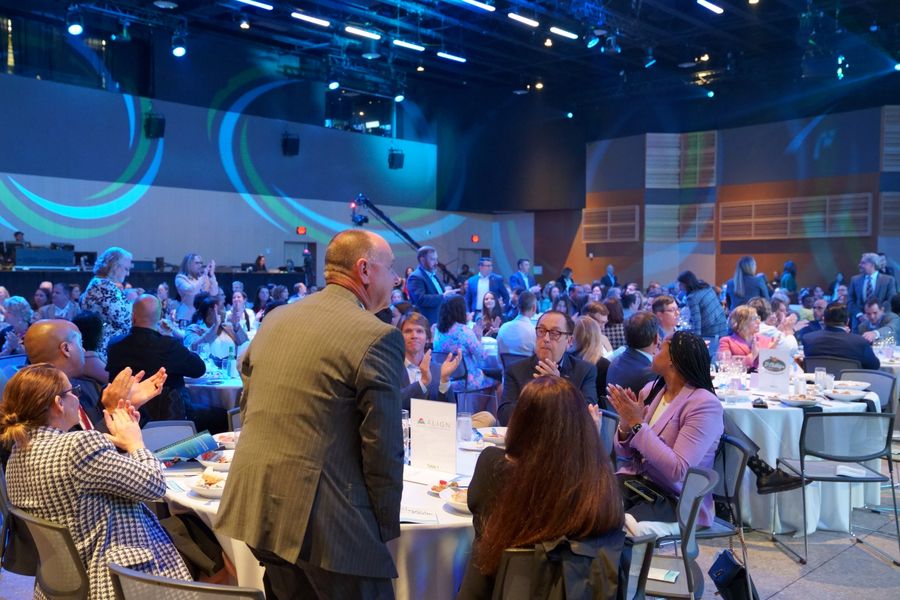 Guests applauding during the dinner program.