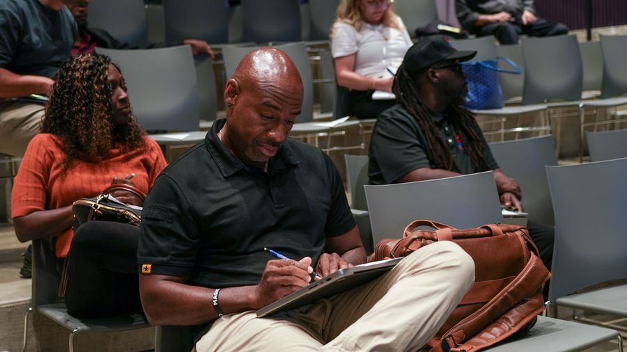 An attendee writes notes during the Inside Google Ads workshop.